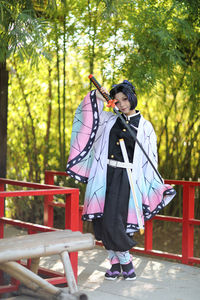 Side view of man standing in forest