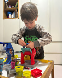 Boy playing with toys at home