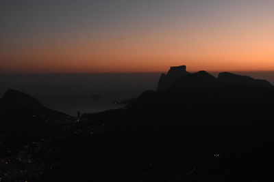 Scenic view of silhouette mountains against sky at sunset