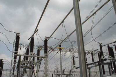 Low angle view of electricity pylon against sky