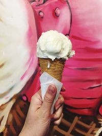 Cropped hand holding ice cream cone