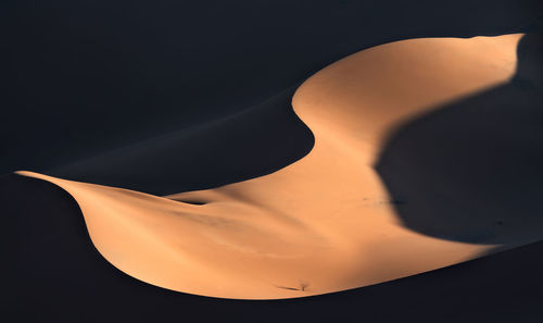 Close-up of silhouette airplane against sky at sunset