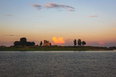 Scenic view of lake against sky during sunset