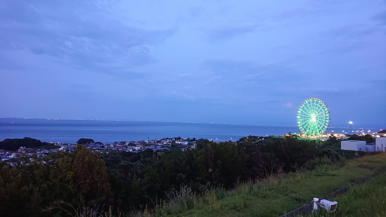 PANORAMIC VIEW OF ILLUMINATED BEACH AGAINST SKY