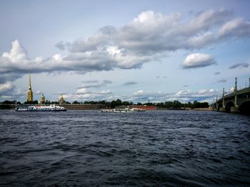 Distant view of city against cloudy sky