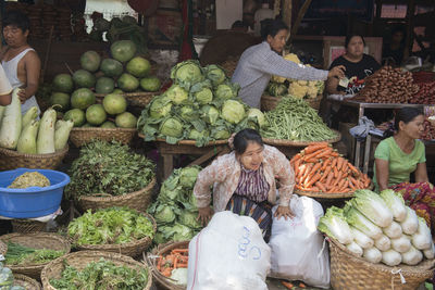 Vendors selling vegetables at market
