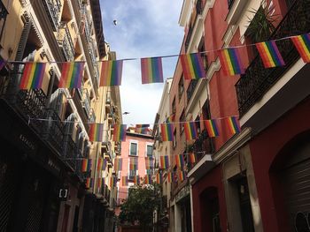 Low angle view of flags hanging against sky