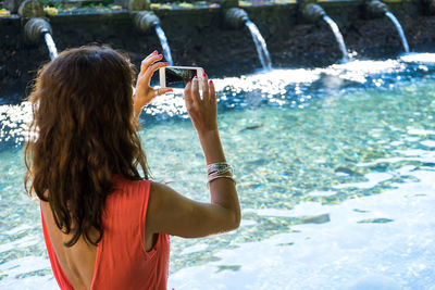 Woman jumping in water