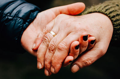 Cropped image of couple holding hands