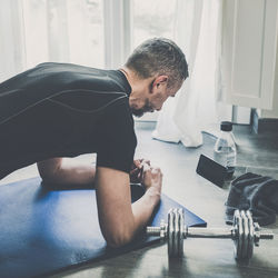 Sporty young man working out and trains at home. fit boy doing push-ups exercises.  health sport gym