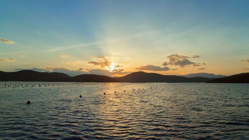 Scenic view of lake against sky during sunset