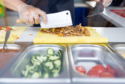 Cropped hand of man holding food