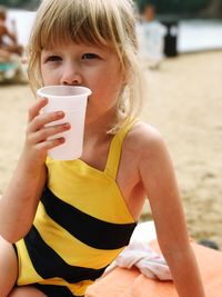 Midsection of woman drinking coffee