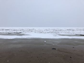 Scenic view of beach against clear sky