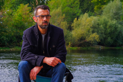 Portrait of man against lake