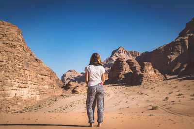 Women standing by rock