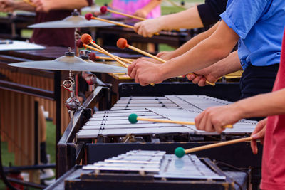 The flashing mallets of the sideline percussionists at rehearsal