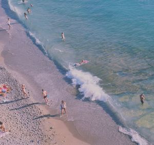 High angle view of people enjoying at beach