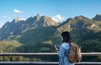 Rear view of man looking at mountains