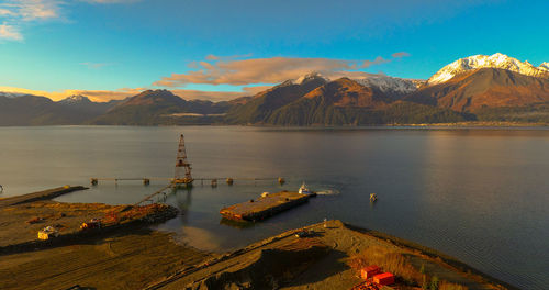 Scenic view of lake by mountains against sky