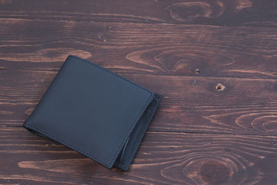 High angle view of wallet on hardwood floor