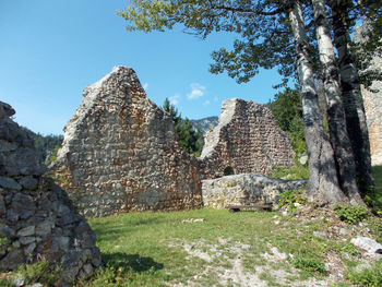 Old ruin building on field against sky