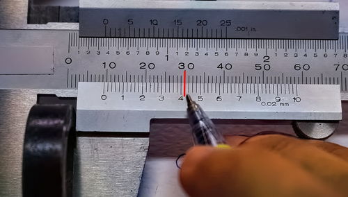 Close-up of hand holding camera on table