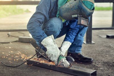 Low section of man sitting outdoors