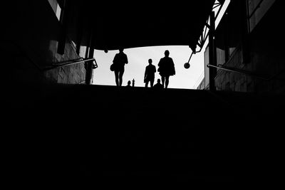 Rear view of silhouette people walking in subway