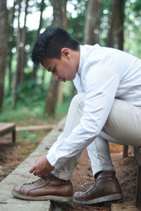 Man tying shoelaces