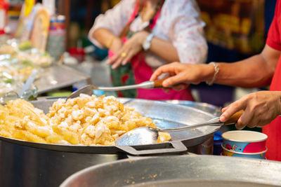 Midsection of man preparing food in kitchen