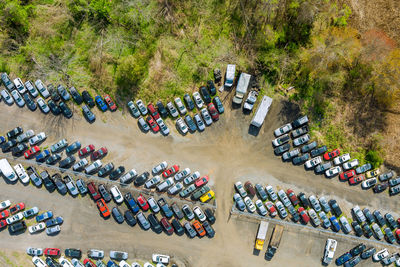 High angle view of vehicles on road by trees