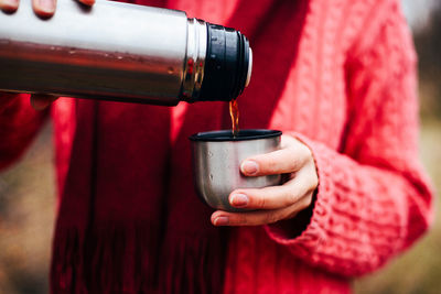 Close-up of hand pouring tea