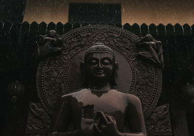 Close-up of statue against building