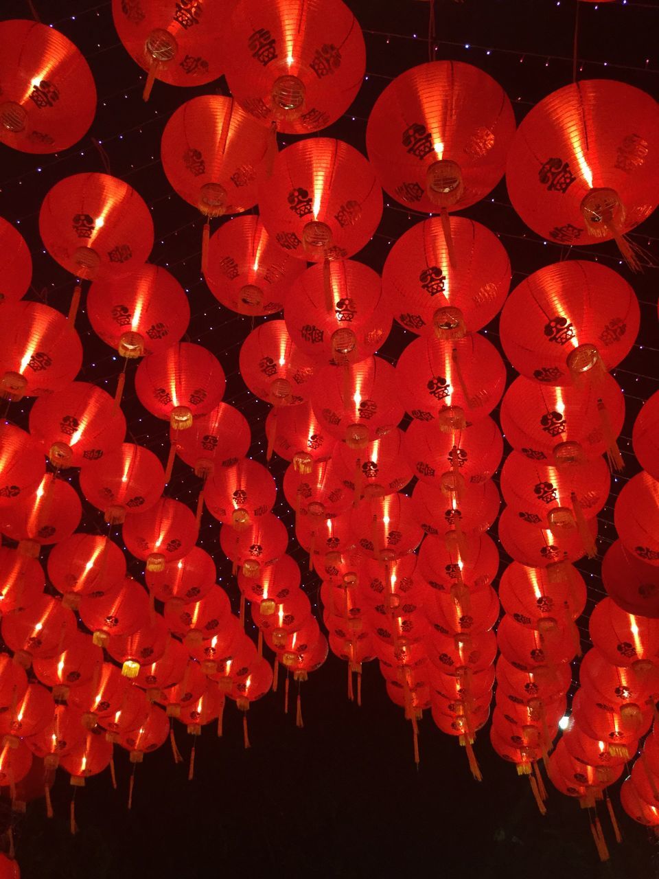 hanging, chinese new year, chinese lantern festival, chinese lantern, red, lantern, low angle view, large group of objects, lighting equipment, cultures, sky, no people, paper lantern, outdoors, night, close-up