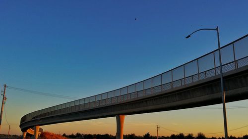 Low angle view of bridge against blue sky