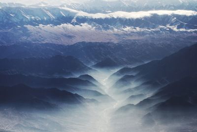 High angle view of rocky mountains during foggy weather