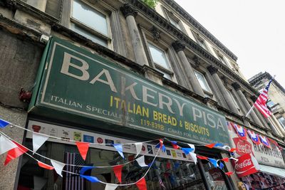 Low angle view of text on building against sky