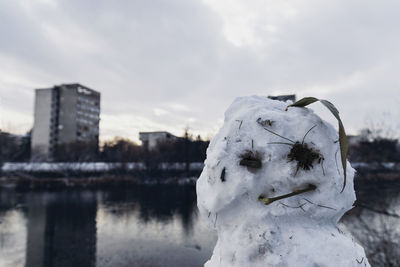 Close-up of frozen lake against sky