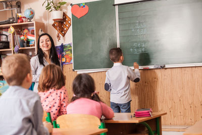 Student solving mathematics on board