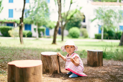 Full length of cute girl wearing hat against trees