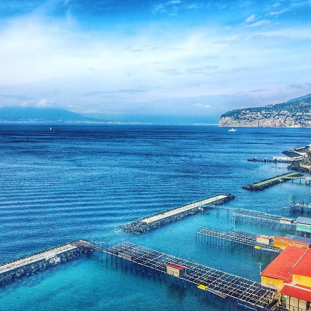 sea, water, horizon over water, blue, sky, scenics, tranquil scene, tranquility, beauty in nature, nature, idyllic, cloud - sky, transportation, nautical vessel, pier, beach, turquoise colored, high angle view, waterfront, seascape