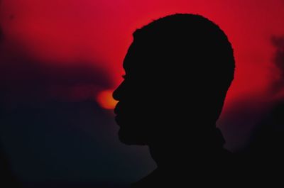 Silhouette man against sky during sunset