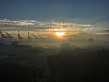 Silhouette cityscape against sky during sunset