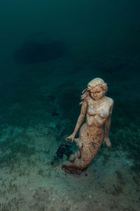 A mermaid statue in the lake fernsteinsee