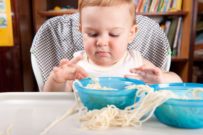 Portrait of baby girl in bowl on table