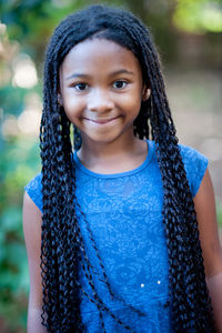 Portrait of smiling girl standing outdoors