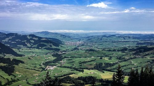 Aerial view of landscape against blue sky