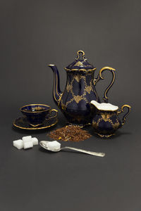 Close-up of tea cup on table against black background