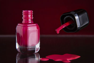 Close-up of red nail paint on table